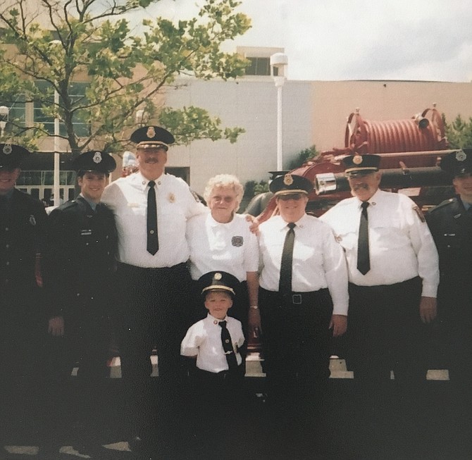 Long-time Cabin John Park Volunteer Fire Department Auxiliary President Mary Morgal, center, is flanked by former Chief James Seavey, left and Kathy Donahoe, right at the annual Maryland State Fireman’s Association convention. In front is her great-grandson.