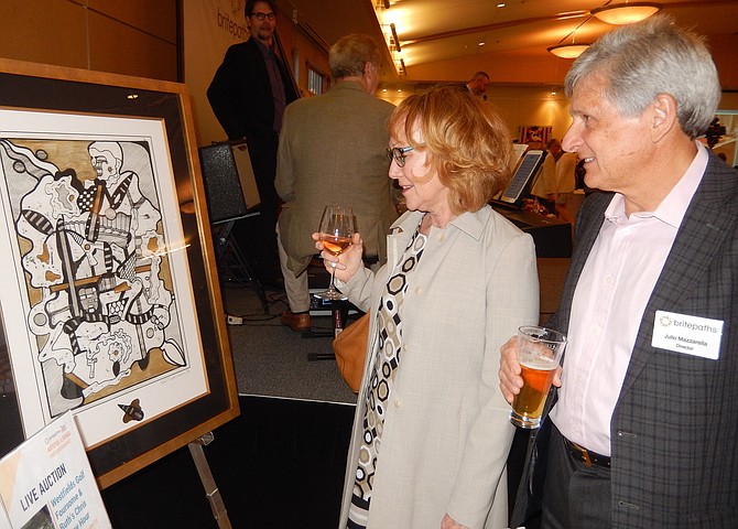 Kim and Julio Mazzarella peruse the artwork during last year’s event.