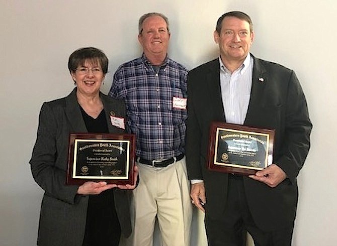 Supervisors Kathy Smith (D-Sully District) and Pat Herrity (R-Springfield) receiving recognition plaques from SYA President Gary Flather, for their support to the children and members of SYA.