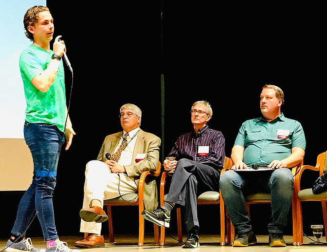 Kenneth Warren, T.C. Williams High School senior and CURE co-founder, discusses the importance of youth environmental activism. Seated (from left) are Bill Skrabak, Andrew Macdonald, and Dean Naujoks.