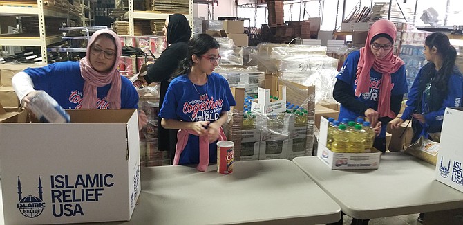 Some 60 volunteers assembled 1,500 food boxes.