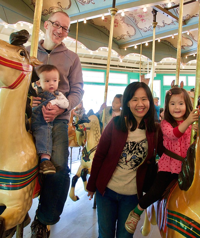 Chris and Henry Gramer, Sook-Yi Yong and Emily Gramer ride the carousel at Glen Echo on Carousel Day.