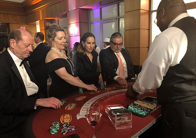 Steve Reed, Joan Renner, India Mertins and Richard Moorhouse enjoy a friendly game of poker at the Symphony Orchestra League of Alexandria’s Gatsby’s Speakeasy II gala April 13 at The Atrium. Now in its 32nd year, the annual SOLA gala raised funds for the Alexandria Symphony Orchestra.