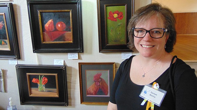 Doreen Montis of Great Falls with her oils, pastels and pottery.