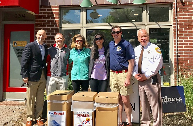 Sheriff Dana Lawhorne, right, stands in front of The Neighborhood Pharmacy with DEA Chief of Diversion Control John Martin and U.S. Attorney’s Office representatives David Peters, Patricia Haines, Lena Munasifi and Zachary Terwilliger during National Prescription Take Back Day April 27 in Del Ray.