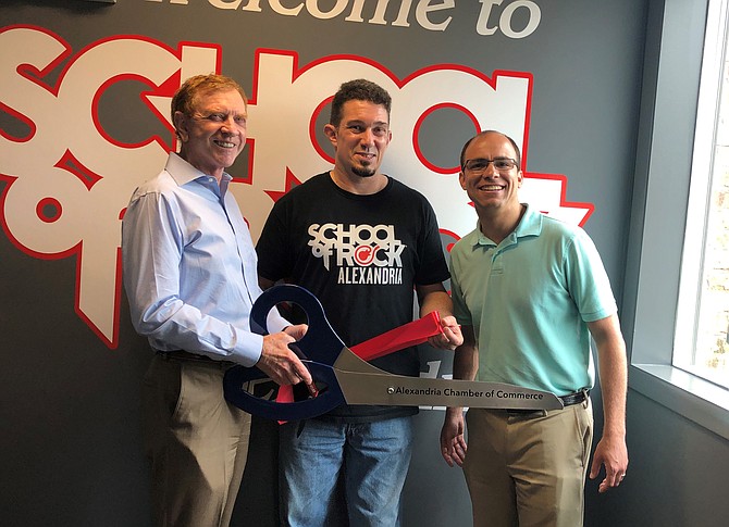 Alexandria School of Rock owner Steve McKay, center, celebrates the May 4 grand opening of the music school’s newest Duke Street location with Chamber of Commerce CEO Joe Haggerty and Mayor Justin Wilson.