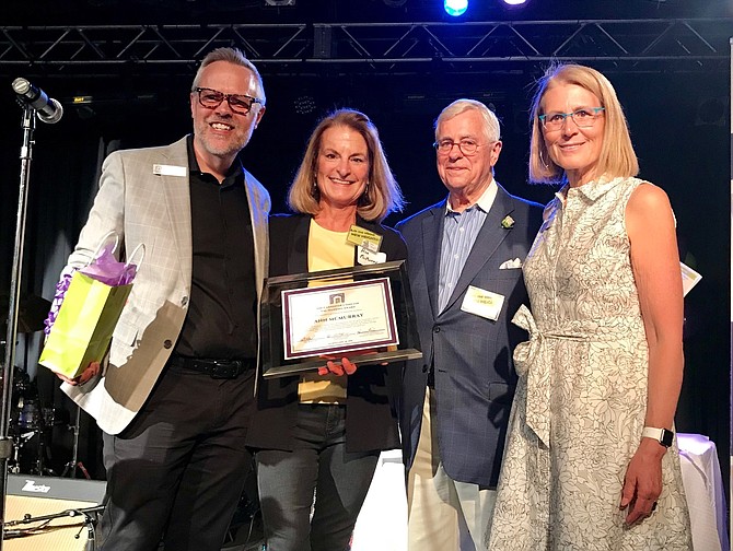 Ann McMurray, second from left, receives the Carpenter’s Shelter Val Hawkins Award during the Carpenter’s Cook-Off April 28 at The Birchmere. Presenting the award to McMurray are Carpenter’s Shelter executive director Shannon Steene, Val Hawkins and board chair Louise Roseman.