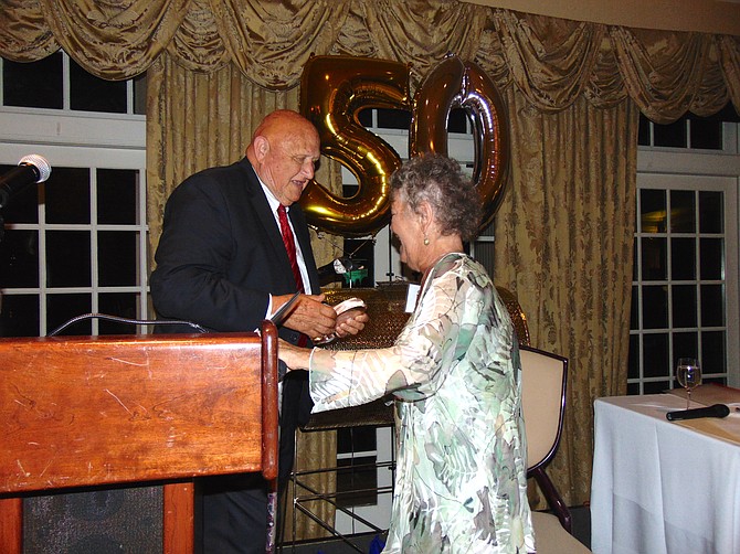 Former Mount Vernon District Supervisor Gerald Hyland presents the GW Hyland Humanitarian Award to Addy Krizek.