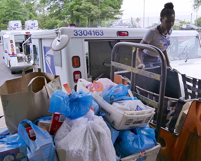 Trucks line up at the Arlington Post Office North Station to deliver food donated by Arlingtonians on Saturday, May 11.