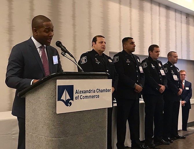 NBC4 news anchor Aaron Gilchrist, left, details the heroics of police officers Osama Sharif, David Daniels, Asad Nawaz and Wesley Vitale following the presentation of Bronze Medals at the Chamber of Commerce Valor Awards May 7 at the Holiday Inn and Suites in Old Town.