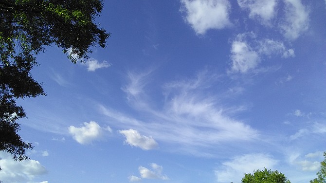 From Geri Baldwin: "The photo reminds me of the cool breeze throughout the sky and how I would fan my mother during days of hot weather and she would smile. In some sense it's like the photo of clouds are like angel wings in the far upper right."