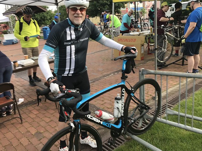 Tim Taylor of Chantilly stops at the Herndon Pit Stop to get a free t-shirt on Bike to Work Day 2019.