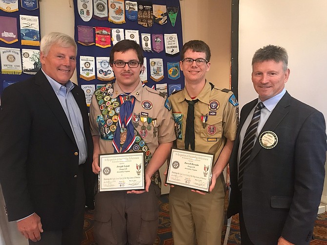 Eagle Scouts Russell Biesada and Joseph Lepak of Alexandria Troop 129 pose with Rear Admiral Stephen Oswald (ret) and Don Simpson Jr. at the 21st annual Rotary Scout Luncheon May 21 at Belle Haven Country Club. Biesada and Lepak were presented with Eagle Scout Scholarships on behalf of the Rotary organization.