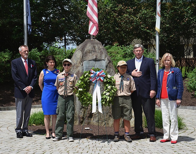 Elected officials participated in the remembrance ceremony as well. From far right, Great Falls Freedom Memorial president Andy Wilson is joined by, from left, State Sen. Barbara Favola (D-31), Dranesville Supervisor John Foust, and Del. Kathleen Murphy (D-34) to stand with Scouts Tommy Maxon and Melinda Hauda for the Laying of the Wreath at the Memorial.