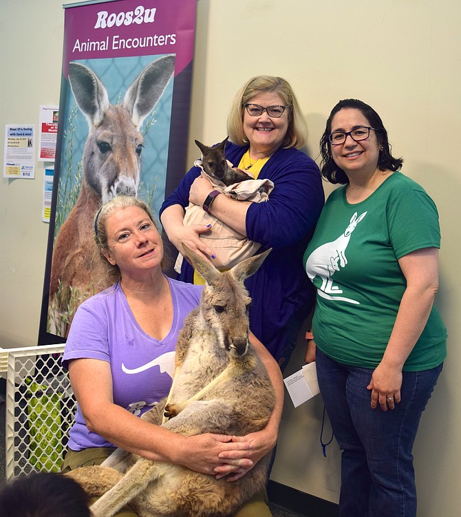 From left, Cassidy Jagger holding Boomeroo, a 7-year-old female Kangaroo, and Tracy Johnson, Potomac library employee, holding an 8-month-old female Wallaby named Clara, and Cindy Gil, also a library employee.