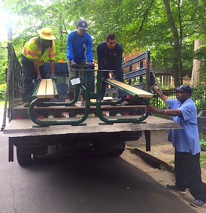 Recreation and Parks workers unload a new picnic table at Monticello Park.