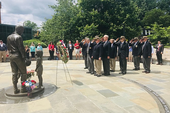 Members of the United States Military Academy class of 1959 salute after placing a wreath at the statue of classmate Humbert “Rocky” Versace during the Memorial Day Ceremony May 27 at the Captain Rocky Versace Plaza and Vietnam Veterans Memorial in Del Ray.