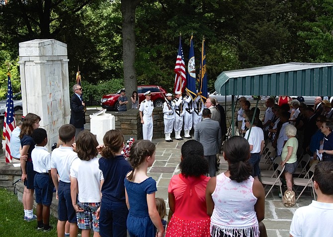 Attendees recite the Pledge of Allegiance to open the Memorial Day ceremony May 27 at Alexandria National Cemetery.