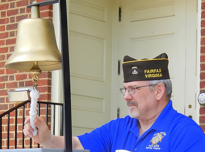 VFW Post 8469 Vice Commander Mac McCarl rings the bell after each name is read.