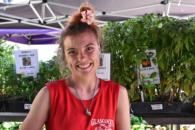 Angel Miller, an employee of Glascock’s Produce, in front of their tomato plants.