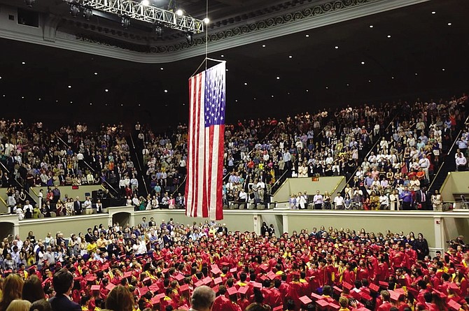 McLean High School Class of 2019 graduates rise for the Star Spangled Banner, performed by the McLean Madrigals and the McLean Band.