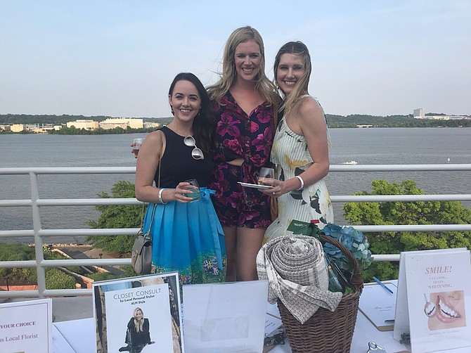 Courtney Pence, Alia Wagenhoffer and Erika Delman enjoy the view of the Potomac River at the Alexandria Seaport Foundation’s Wine on the Water annual fundraiser June 1 at Canal Center Plaza.