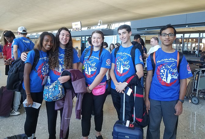 The first group of Herndon High School band members from the Pride of Herndon Marching Band, led by Director of Bands Kathleen Jacoby, prepares to depart Dulles International Airport shortly after noon on Tuesday, June 4, destination Normandy, France and the 75th Anniversary of D-Day.