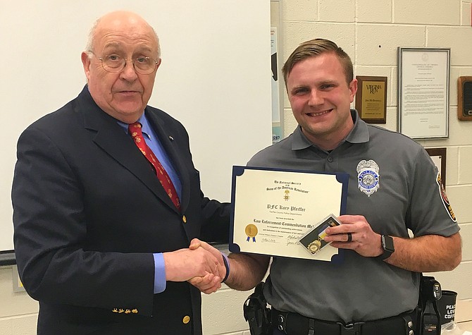 (From left) William Collier presents the SAR Law Enforcement Commendation Medal and Certificate to PFC Kory Pfeiffer.