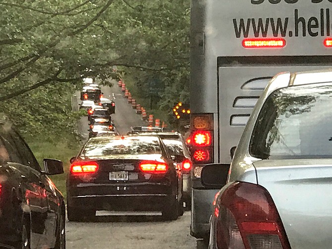 Traffic backs up on the George Washington Parkway northbound to merge around a sinkhole on May 21. When the NPS initially stabilized the sinkhole in mid-May, it was 10 feet deep, 30 feet long and 20 feet wide. Construction will continue through most of the summer.