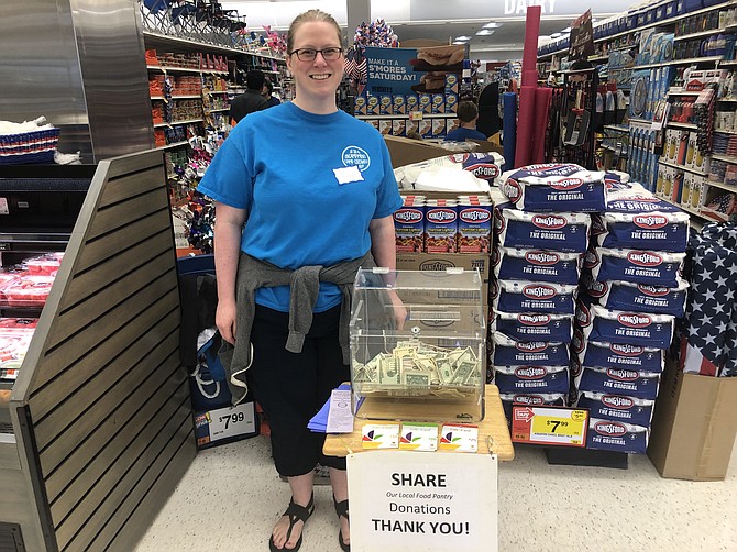 Jennifer Ruscio stood near the checkout aisles inside the grocery store to collect cash and gift card donations from shoppers.