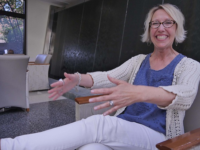 Mary Belanich demonstrates what it feels like for her client to be put flat on a gurney and bundled up in cotton clothing before hyperbaric oxygen treatment at Virginia Hospital Center on June 12.