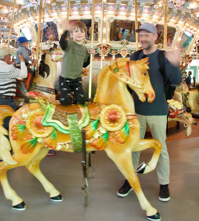 Christian and James Lowe on Carousel Day at Glen Echo. Ride it in May and June because in 2019, the carousel will be closed for construction from July through September. It will reopen in Spring 2020.