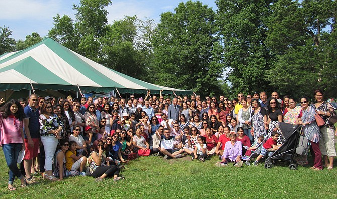 A small segment of the more than four hundred community members who attended the 2019 Model Nepal Society Potluck Picnic gather outside the canopy to record the moment.