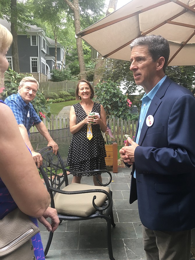 Larry Barnett talks with Jessie Clark and her husband during the event.