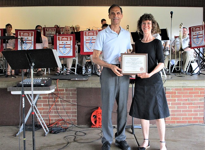 Mount Vernon Community Band Director Linda Davidson, with Mount Vernon District Supervisor Dan Storck, after receiving a plaque of appreciation.