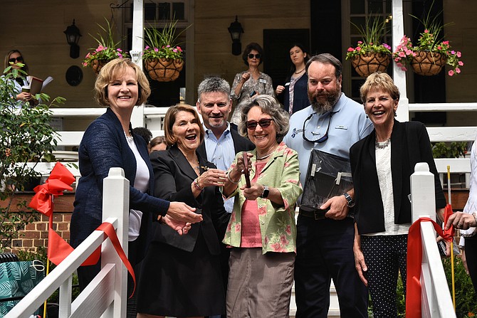 The Ramsay House Visitors Center garden was officially reopened on Wednesday morning, June 12. Garden Club of Alexandria members and co-chairs of the project Vici Boguess, Betsy Huffman and Virginia Banchoff are joined by the construction team that included Construction Manager Donnie Simpson, J&J Landscape Management Inc. President James H. Derrington Jr, and landscape architect Joan Honeyman for the ribbon cutting.