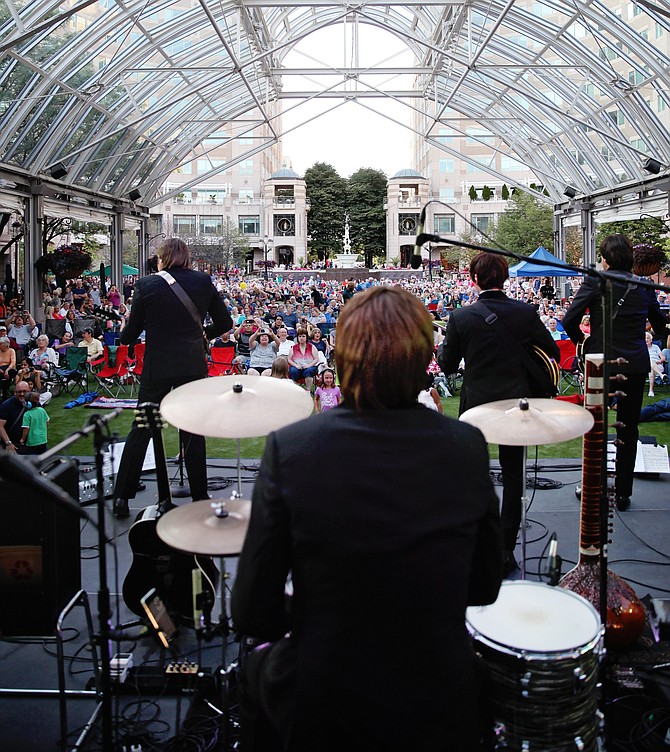 Playing to an audience as far as the eye can see, the Beatles Tribute band, Hard Day's Night, performs at Reston Concerts on the Town Summer 2019.