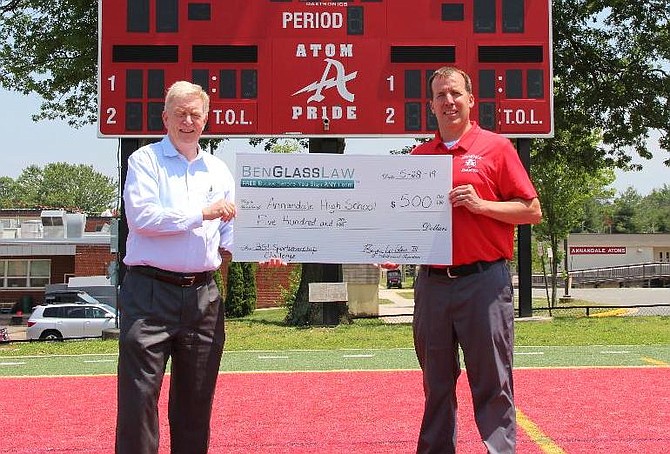 Ben Glass, of Fairfax Station, presents the $500 award to John Ellenberger, Athletics Director at Annandale High School. Head Coach and former marine Tejas Patel (not pictured) has changed the culture of the program for the better.