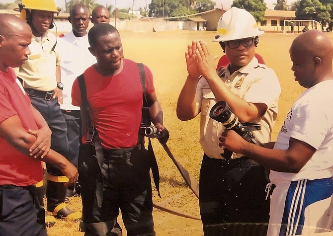 Fairfax County Fire Chief John Butler, second from right, working with Liberian firefighters in January of this year.