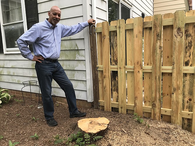 Cory Laws, Housing and Neighborhood Improvement Coordinator for the Town of Herndon, stands where a large tree crashed through a homeowner's fence. He used resources established through his position to take care of the tree, fence and hopefully begin other repairs needed for the home. "The big problem is resources, and I don't have any," said Laws.