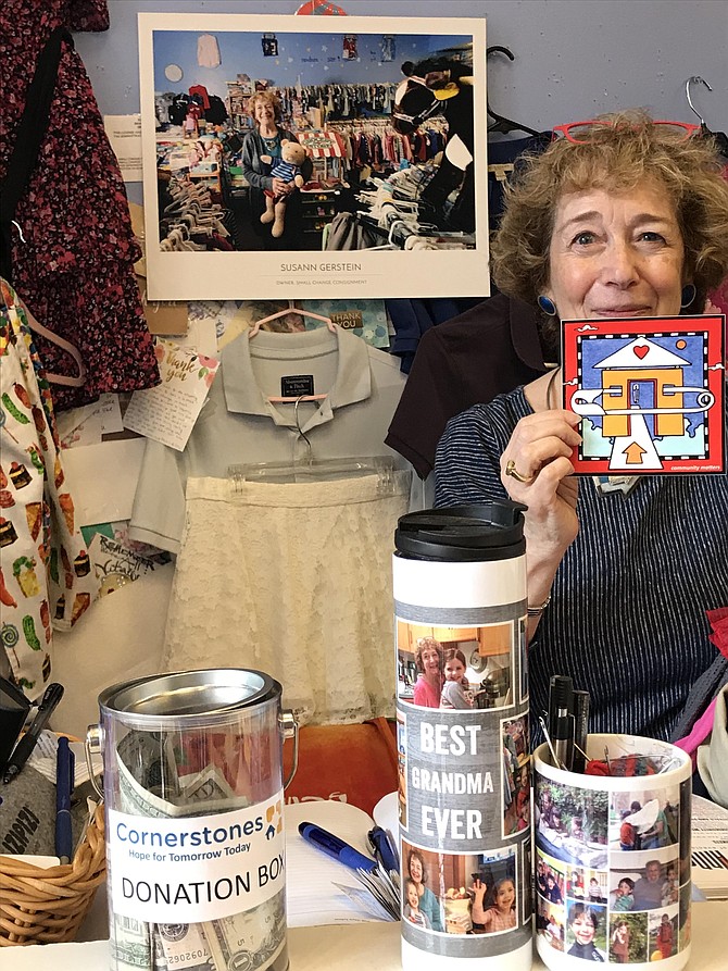 As owner Susann Gerstein prepares to close her shop, Small Change Consignment at Lake Anne Plaza in Reston, she stands behind its counter, with a watercolor painted and gifted to her by local artist, Dana Ann Scheurer, and an image of her in the shop taken by local photographer Charlotte Geary.