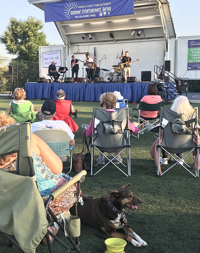 Patrons and pets enjoy the free concert open to the public featuring singer-songwriter Crys Mathews at the Fairfax County Park Authority Summer Entertainment Series held at Arrowbrook Centre Park in Herndon on Saturday, July 13.