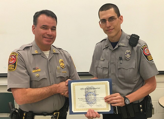 (From left) Capt. Dean Lay, Sully District Station commander, presents the Officer of the Quarter award to Officer Justin Collier.