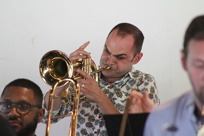 Arsen Sumbatyan plays a trumpet solo during a concert at Fort Hunt Park by The Hot Lanes, a 16-piece jazz band created by Bobby Jasinski.