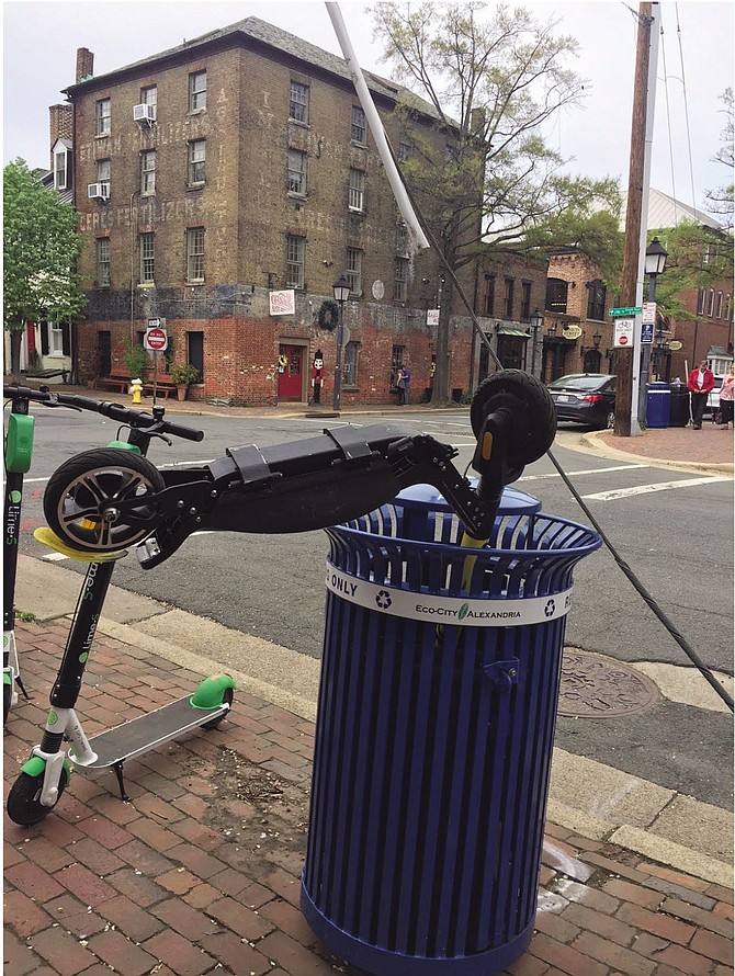 Scooter dumped in Old Town recycling bin.