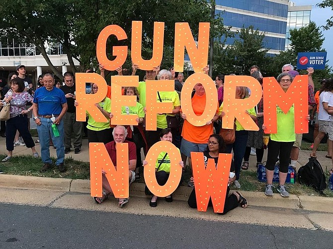 Hundreds of protestors gathered at NRA headquarters in Fairfax Monday, including members of Reston Herndon Indivisible holding these letters.