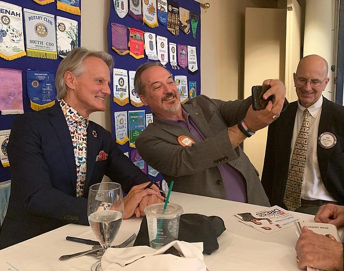 Monte Durham, left, poses for a selfie with Derek Mason as Jack Fannon looks on. Durham was on hand at the Alexandria Rotary Club meeting Aug. 6 at Belle Haven Country Club.