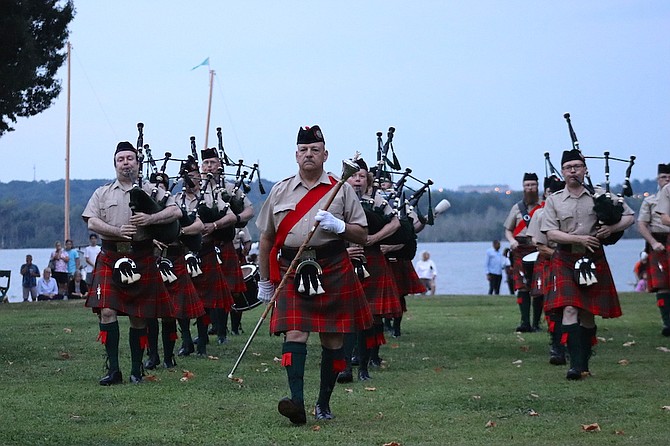 The City of Alexandria Pipes and Drums march off the field at the conclusion of their concert.
