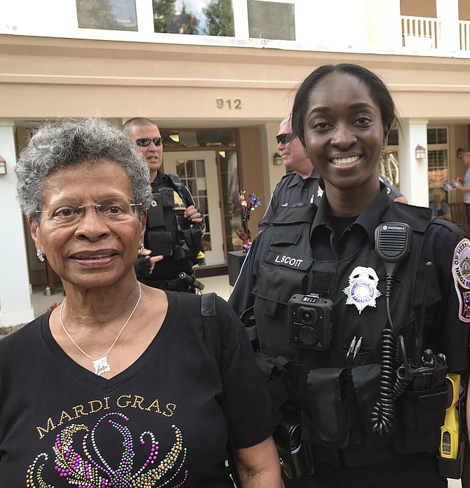 Herndon Harbor House resident Imes Bello greets the newest member of the Herndon Police Department, Officer L. Scott.