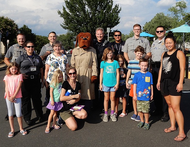 Residents, Sully District police officers and Sully District Supervisor Kathy Smith (to left of McGruff the Crime Dog) attend National Night Out in Brookfield.